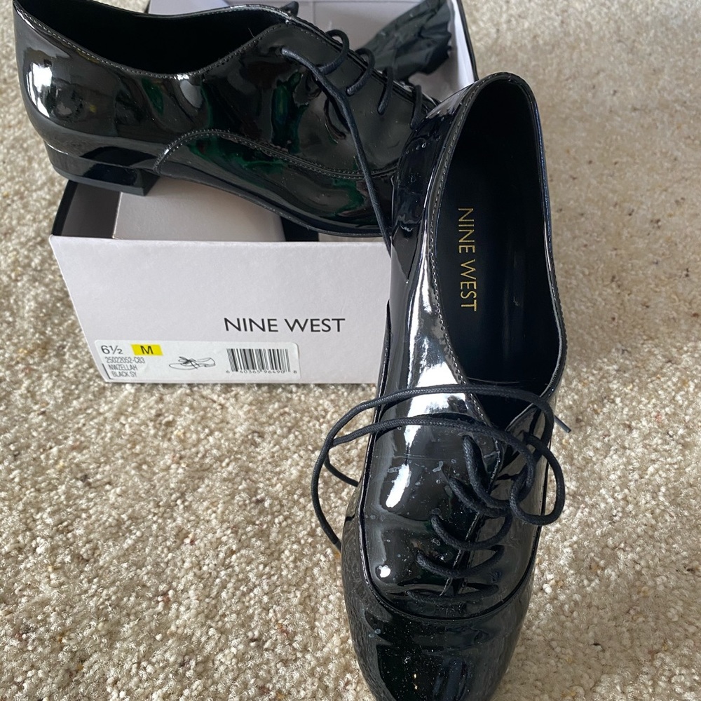 Nine West black patent lace up shoe.